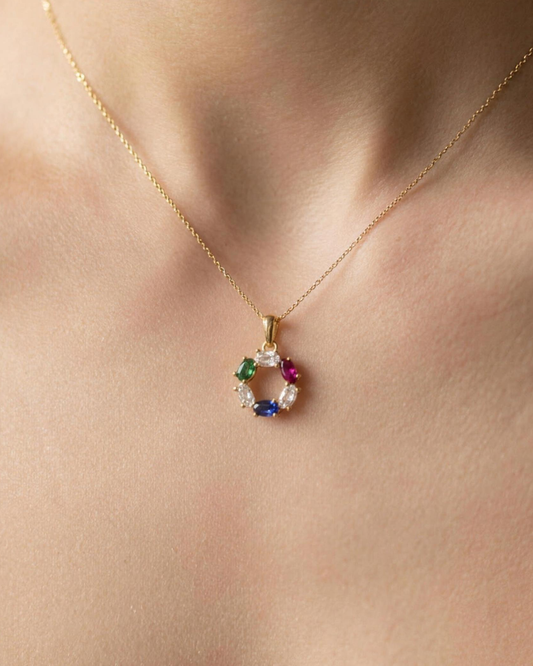 The DNA Representation Pendant worn at the collarbone, showing its small everyday scale of about 25mm