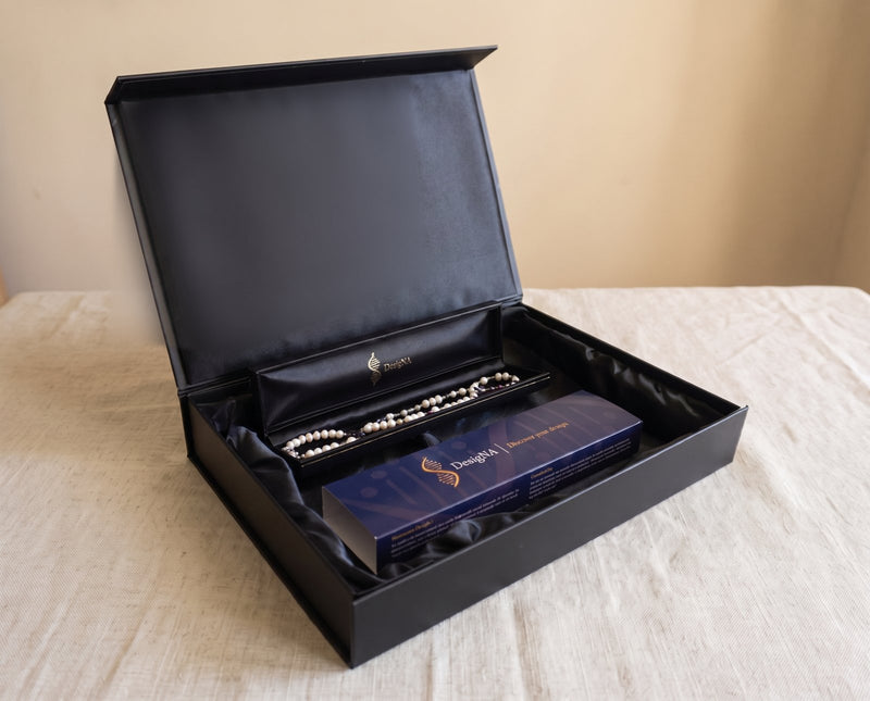 The finished DesigNA piece presented in the open black box with the navy sleeve
