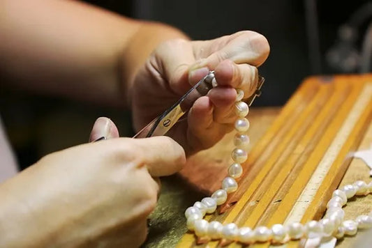 Handmade jewellery Birmingham Jewellery Quarter: a DesigNA strand strung by hand beside its certificate