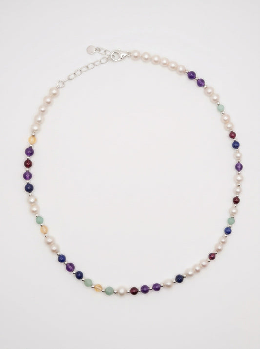 DesigNA pearl DNA necklace worn at the collarbone