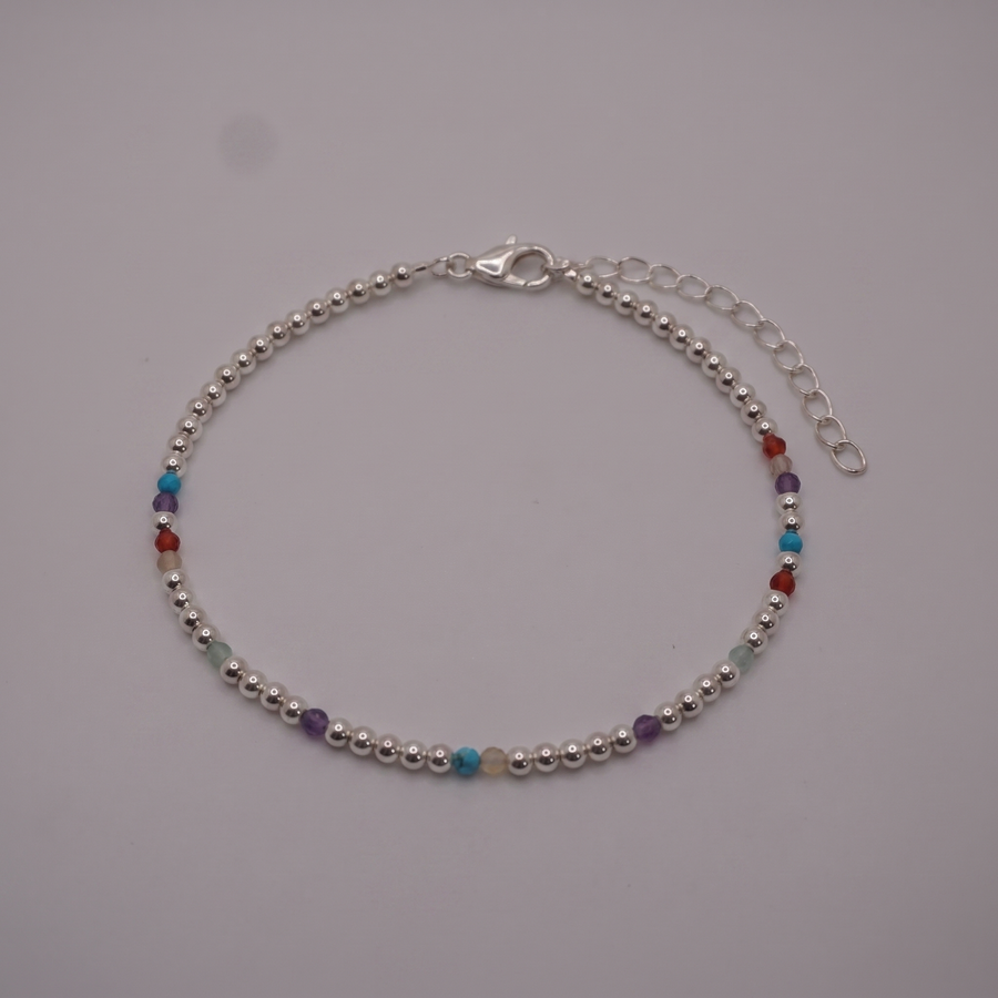 DNA bracelet range in silver, laid flat showing the coloured stone markers
