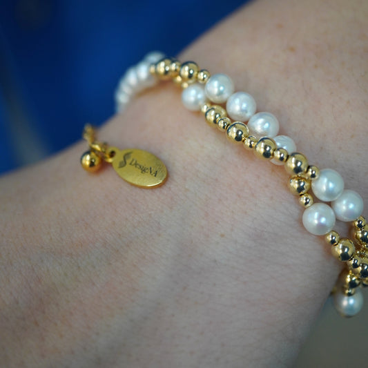 Twisted Pearl and Gold DNA Profile Bracelet worn on the wrist