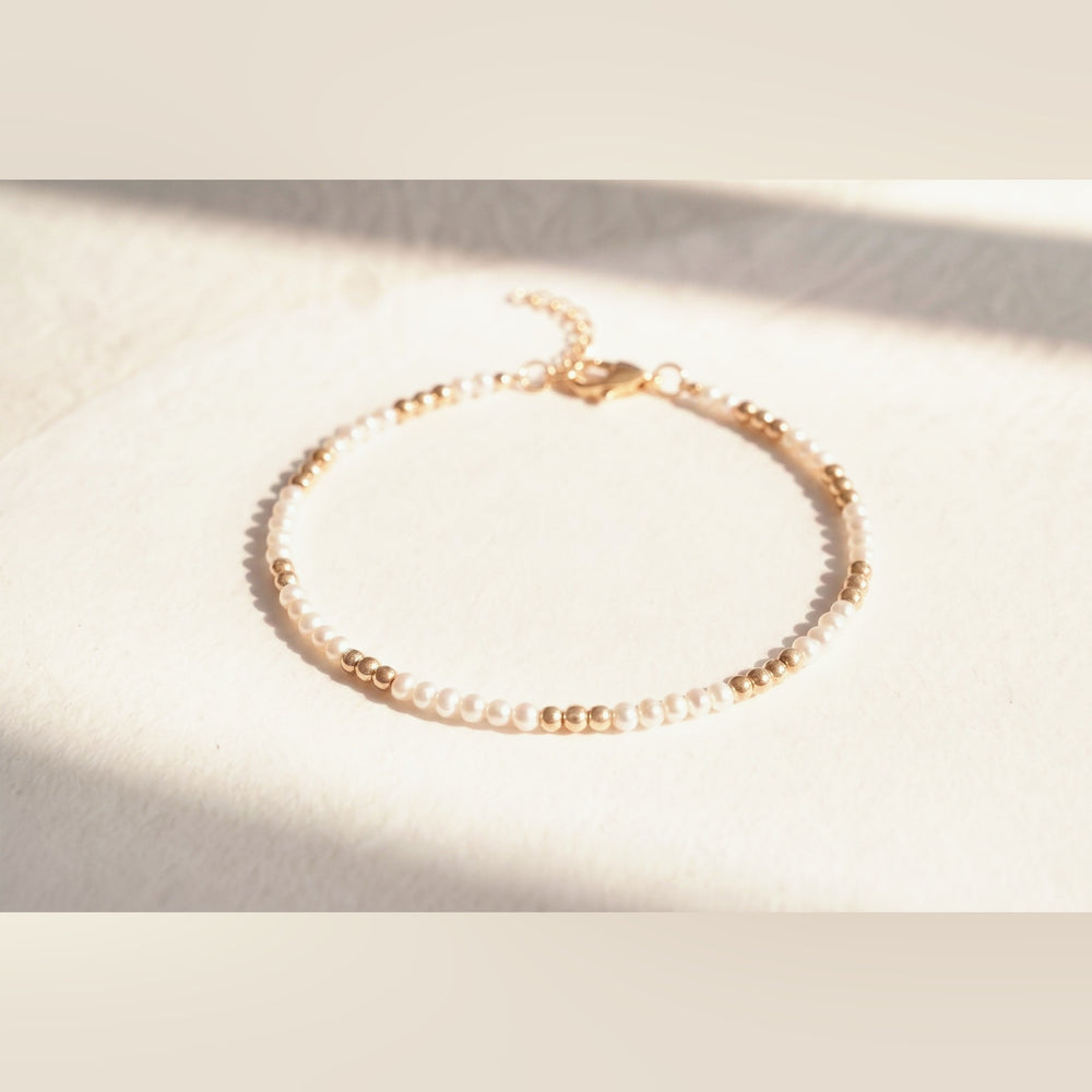Pearl and Gold Clasp DNA Profile Bracelet, flat lay