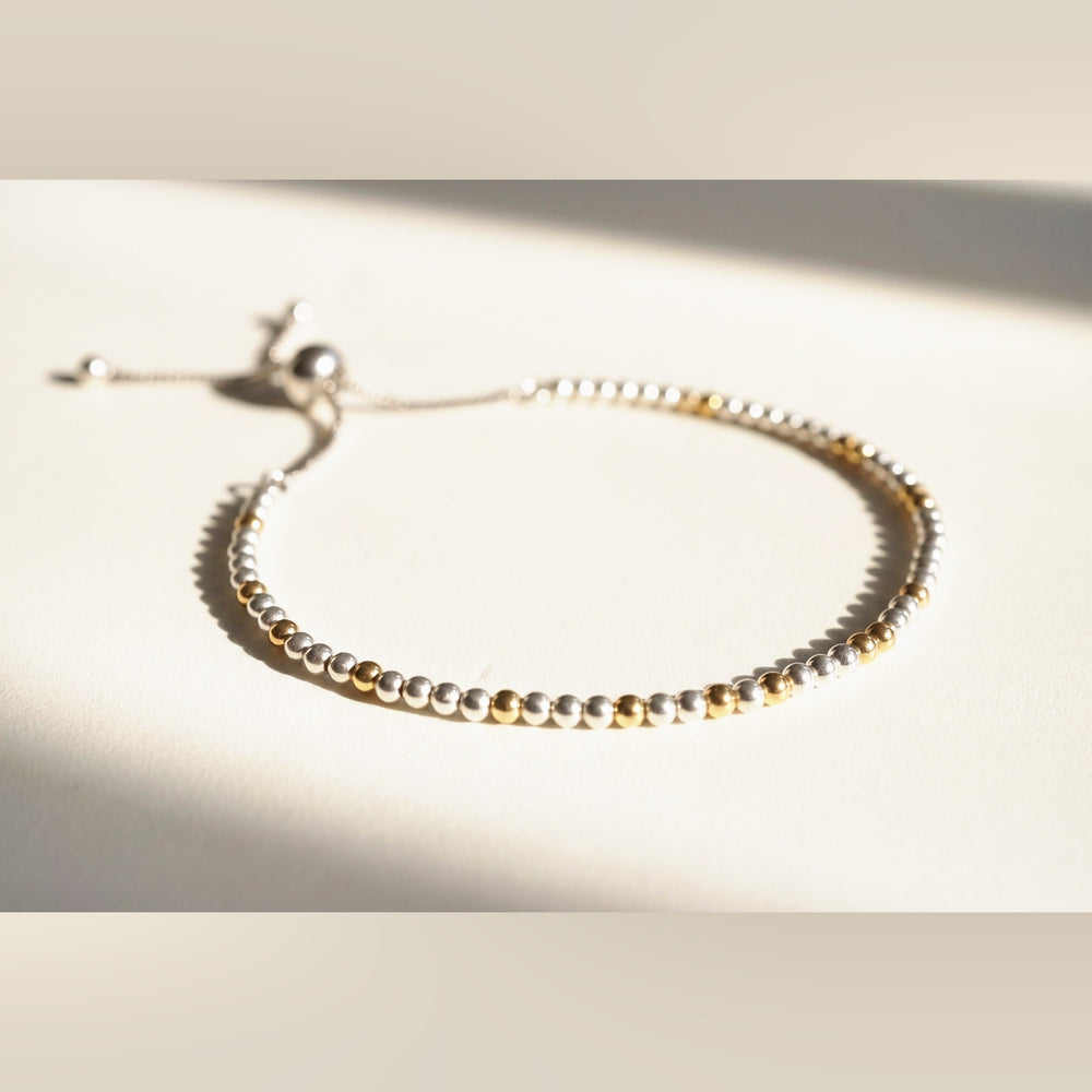 Spider Silver and Gold DNA Profile Bracelet, flat lay