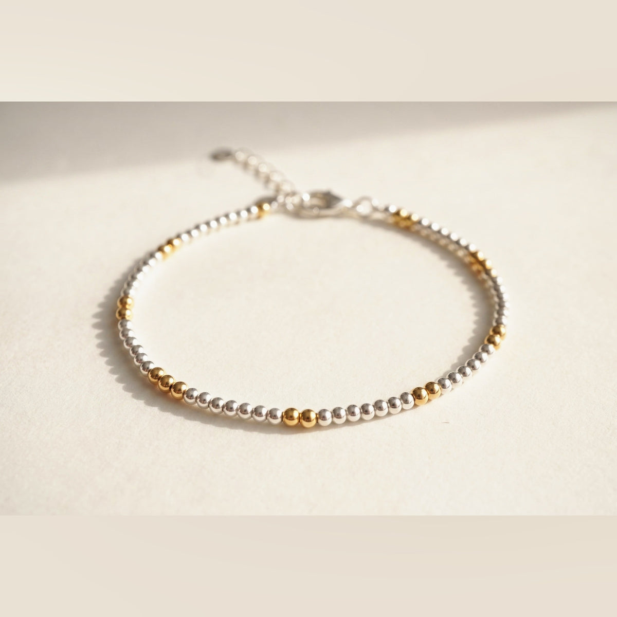 Silver and Gold Clasp DNA Profile Bracelet, flat lay