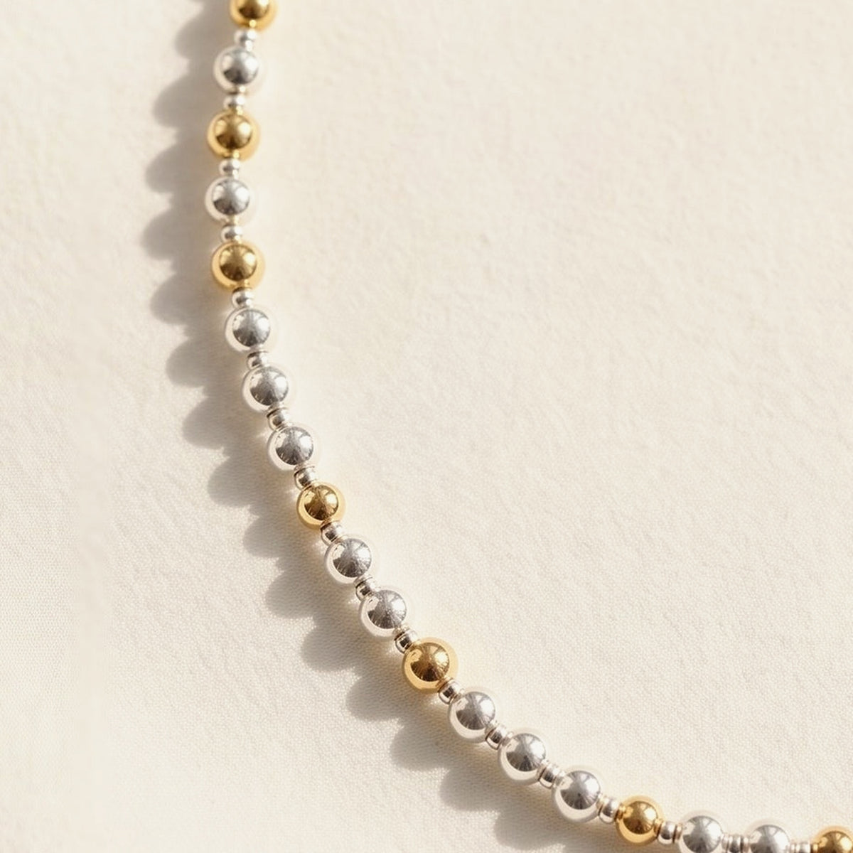 Silver and Gold Pattern DNA Profile Necklace, close up of the strand
