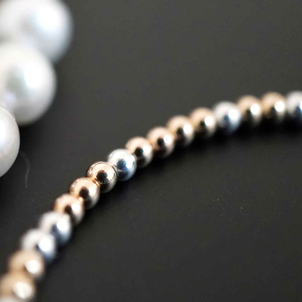 Silver and Gold Clasp DNA Profile Bracelet, close up of the strand