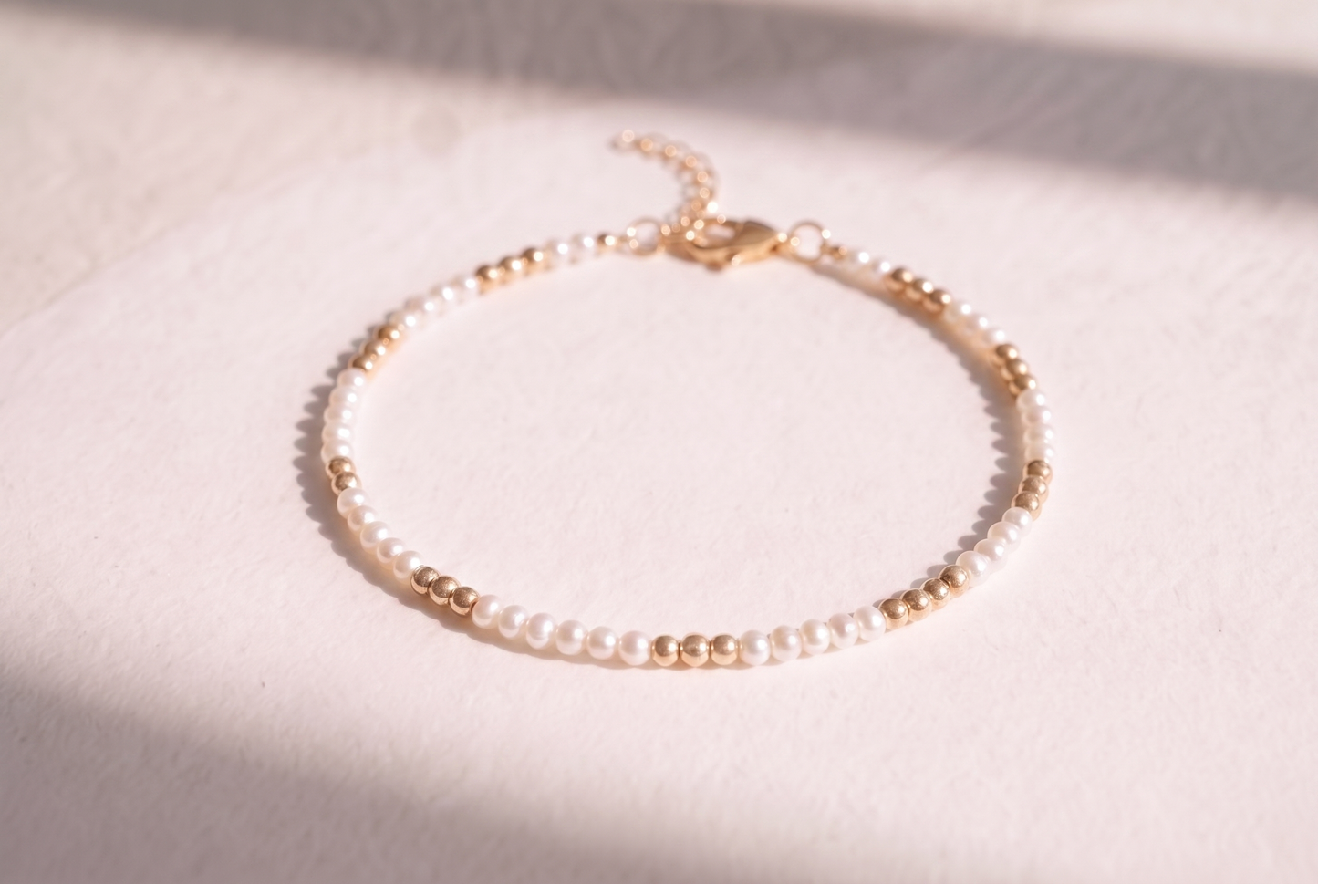 Pearl and Gold Clasp DNA Profile Bracelet, freshwater pearls with gold spheres marking the DNA positions, gold lobster clasp and extension chain
