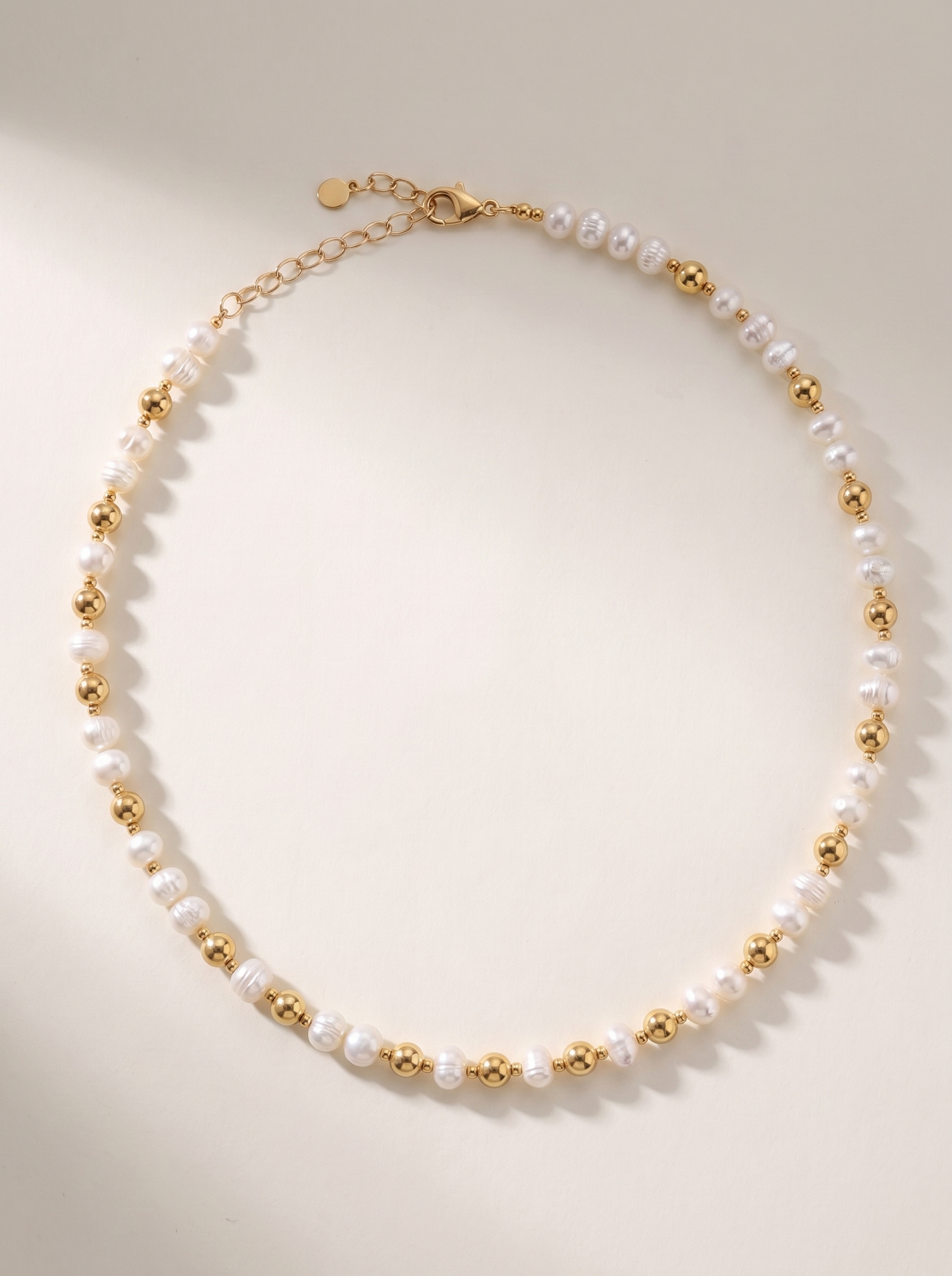 Pearl and Gold Pattern DNA Profile Necklace laid flat, freshwater pearls with gold spheres marking the DNA positions