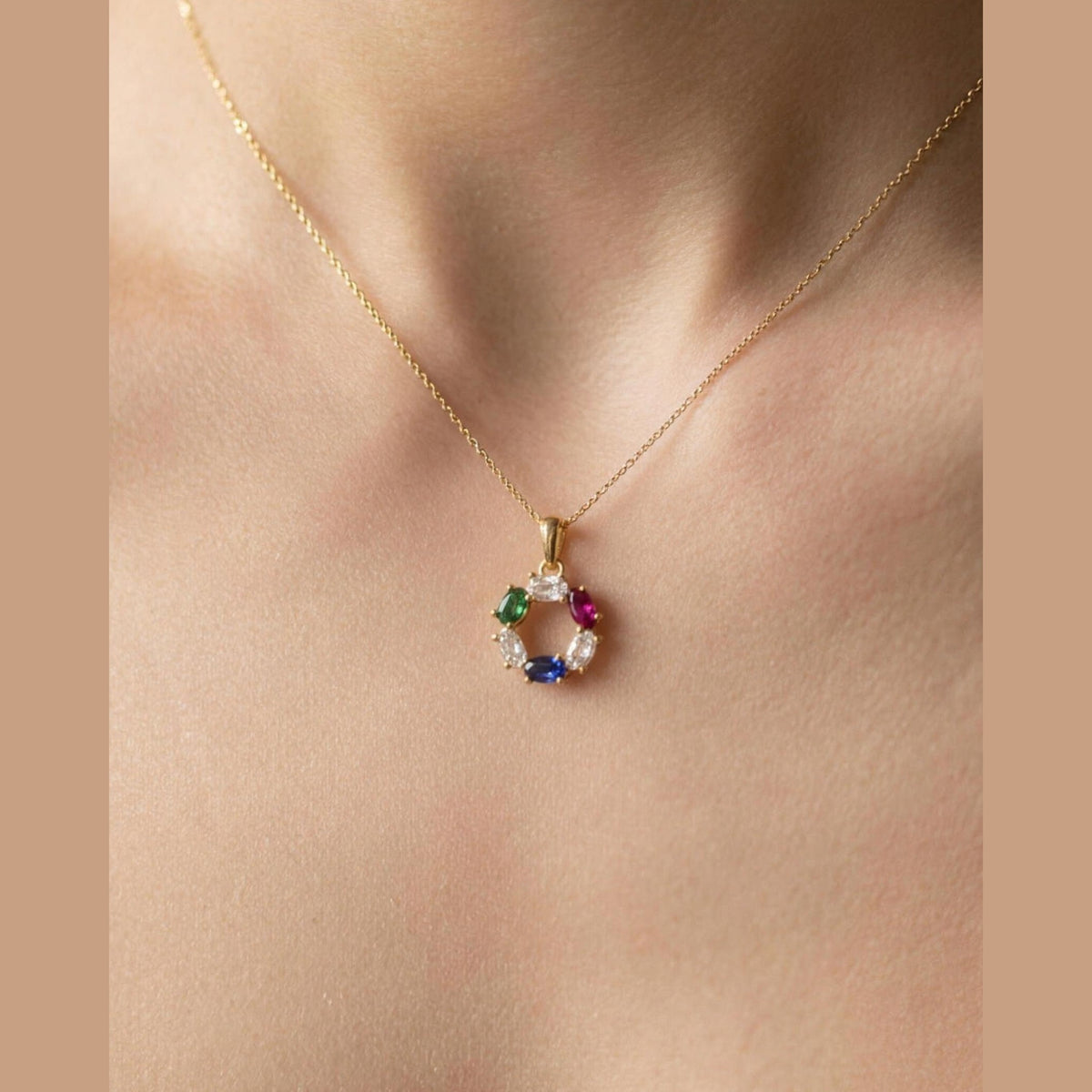 The DNA Representation Pendant worn at the collarbone, showing its small everyday scale of about 25mm