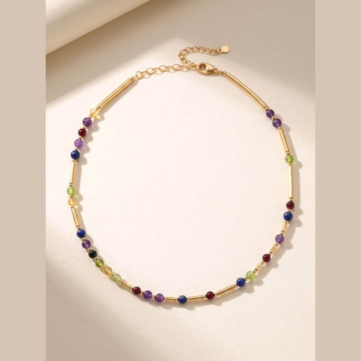 Gold DNA Profile Necklace, gemstone markers set between 9ct gold batons in the order the DNA places them