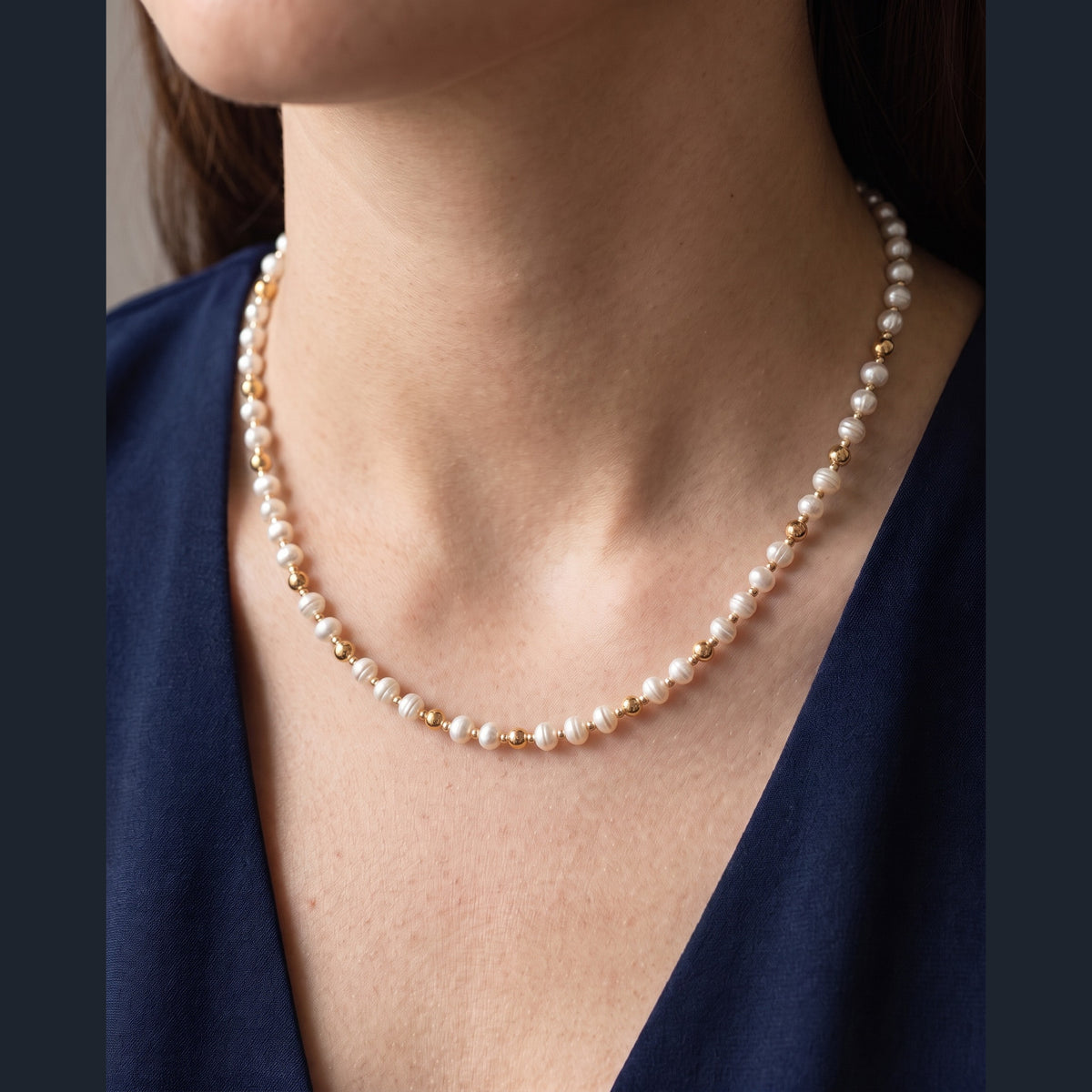 Pearl and Gold Pattern DNA Profile Necklace worn on the neck
