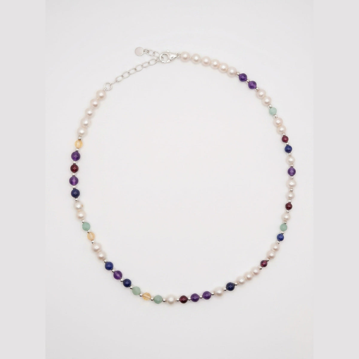 Pearl DNA Profile Necklace laid flat in an oval loop on a soft white background
