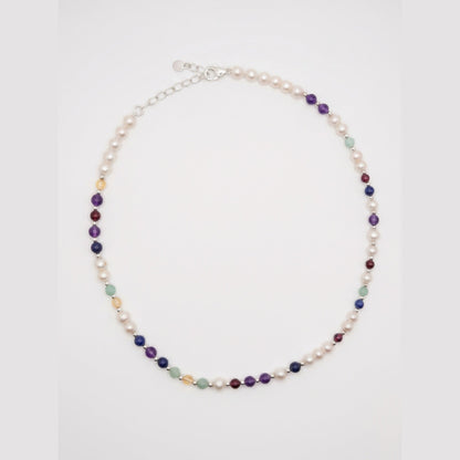 Pearl DNA Profile Necklace laid flat in an oval loop on a soft white background