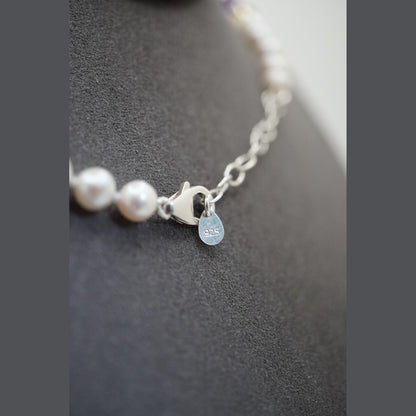 Close up of the pearl necklace clasp, extender chain and stamped 925 disc
