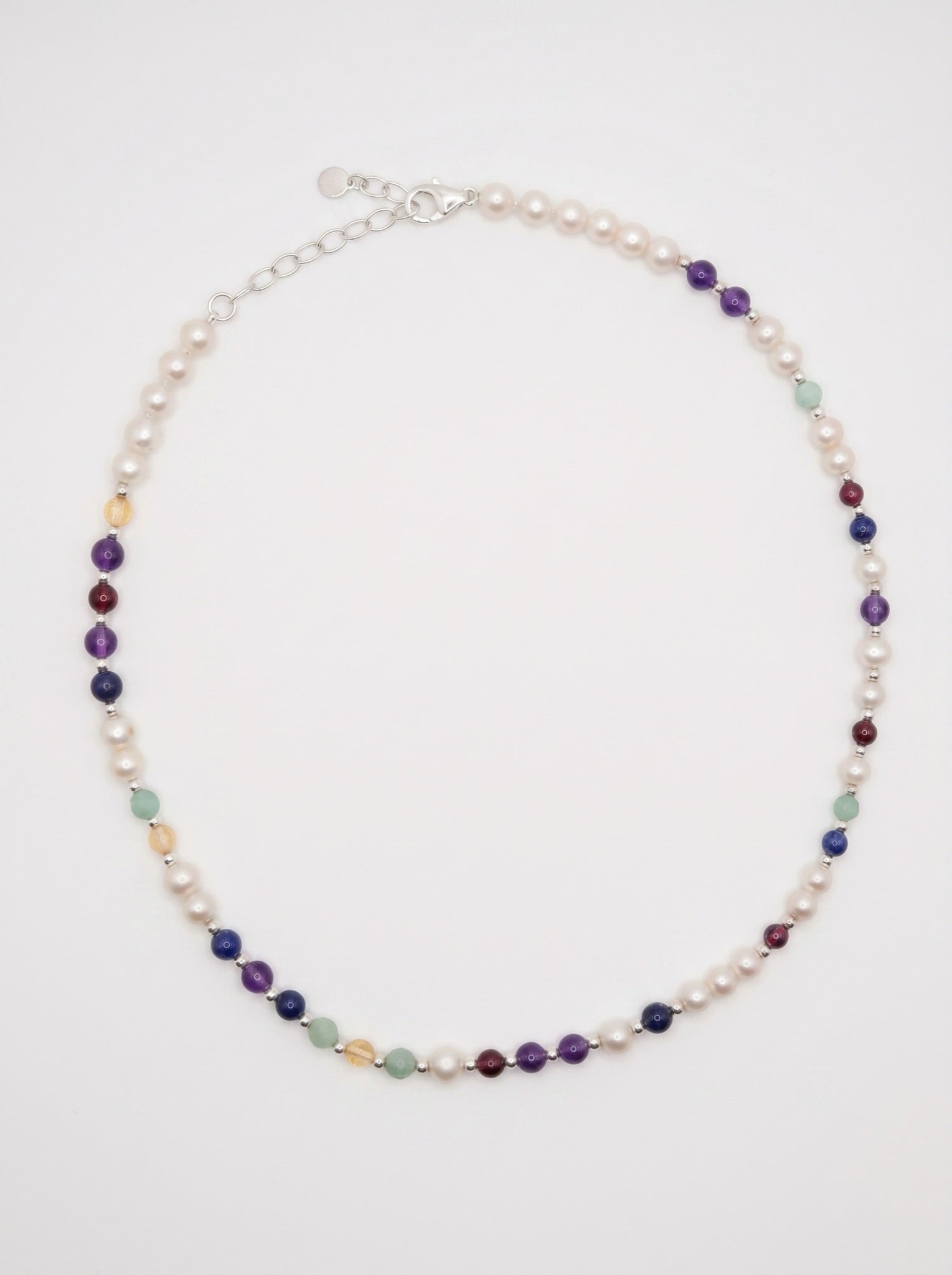 Pearl DNA Profile Necklace laid flat in an oval loop on a soft white background