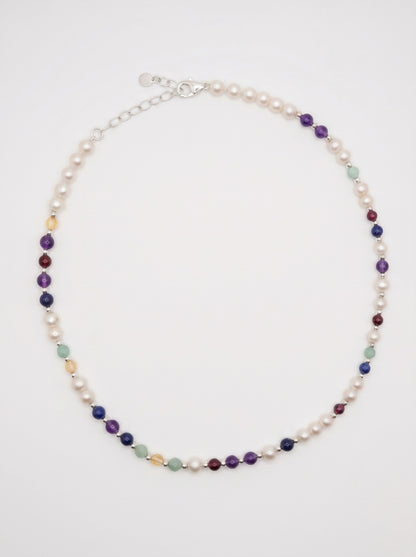 Pearl DNA Profile Necklace laid flat in an oval loop on a soft white background