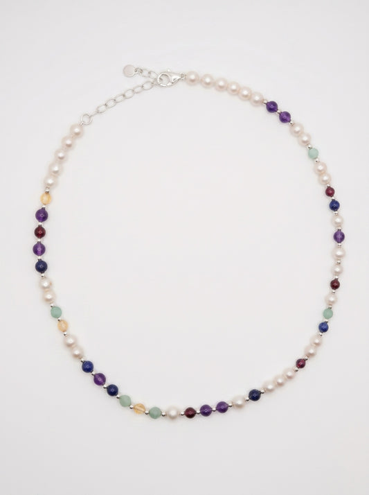 Pearl DNA Profile Necklace laid flat in an oval loop on a soft white background