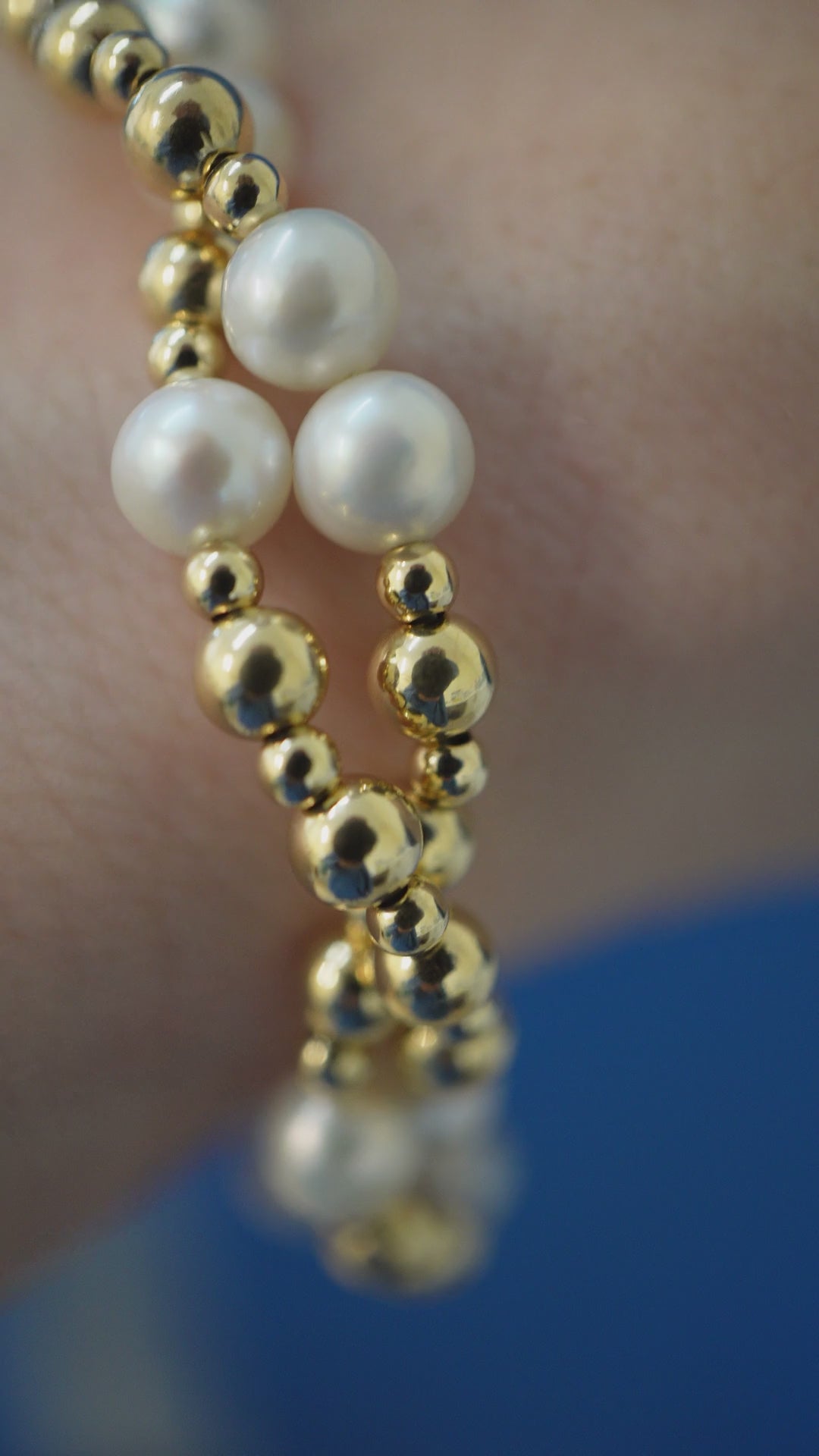 Twisted Pearl and Gold bracelet on the wrist, macro pulling back to the whole piece