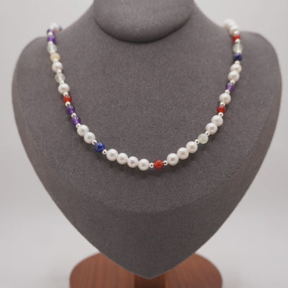 Pearl DNA Profile Necklace on the display bust, light moving across the pearls