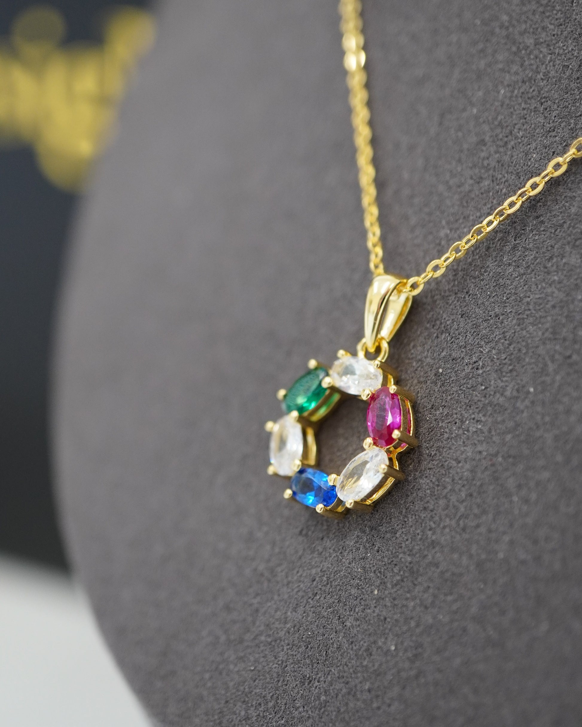 Side view of the DNA Representation Pendant hanging on its gold cable chain