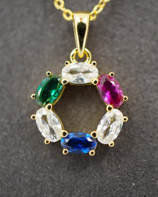 DNA Representation Pendant, a circular gold plated setting with six oval zircon stones on a fine cable chain