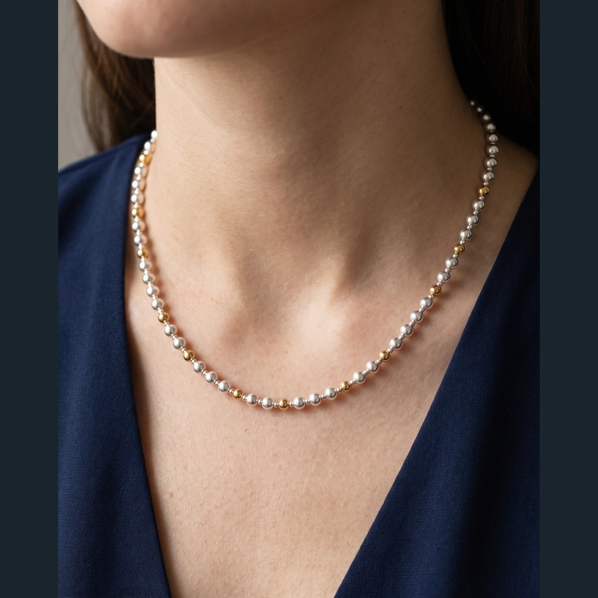 Silver and Gold Pattern DNA Profile Necklace worn on the neck