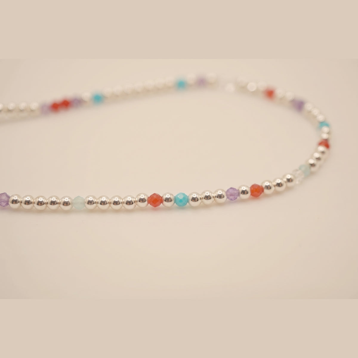 Macro of the Silver Clasp DNA Profile Bracelet showing the 2mm silver spheres and gemstone markers