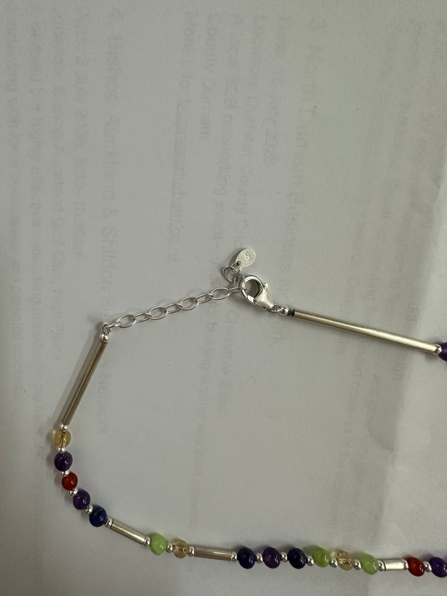Close up of the silver necklace clasp, extender chain and stamped 925 disc