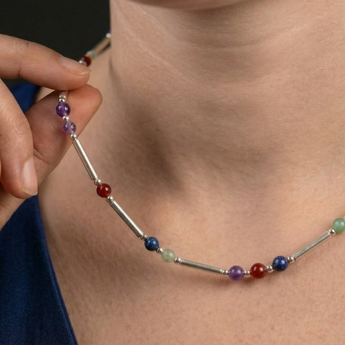 Silver DNA Profile Necklace worn on the neck, close crop with no face shown