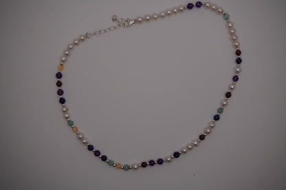 Silver DNA Profile Necklace laid flat on a soft grey background