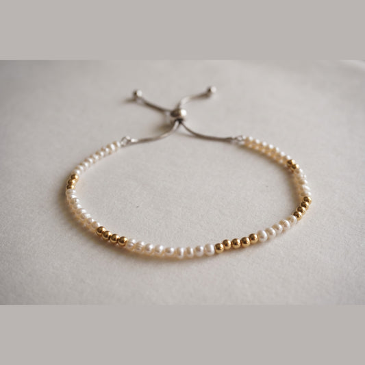 Spider Pearl and Gold DNA Profile Bracelet with small pearls and gold markers, adjustable slider clasp