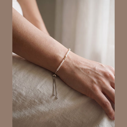 Spider Pearl and Gold DNA Profile Bracelet worn on the wrist