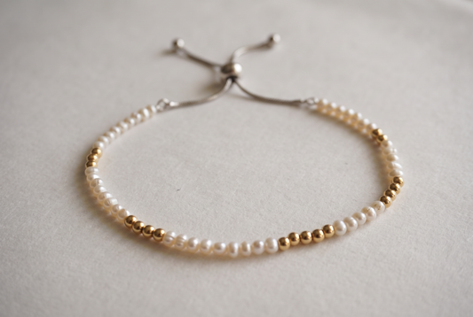 Spider Pearl and Gold Bracelet with small pearls and gold marker beads, adjustable slider clasp