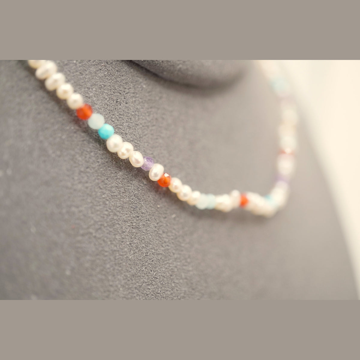 Macro of the Spider Pearl Clasp DNA Profile Bracelet showing 2mm pearls and faceted gemstone markers