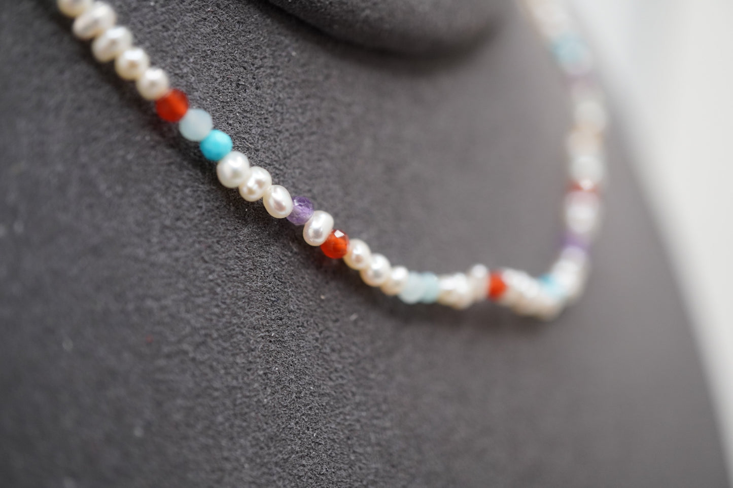 Macro of the Spider Pearl Clasp Bracelet showing 2mm pearls and faceted gemstone markers