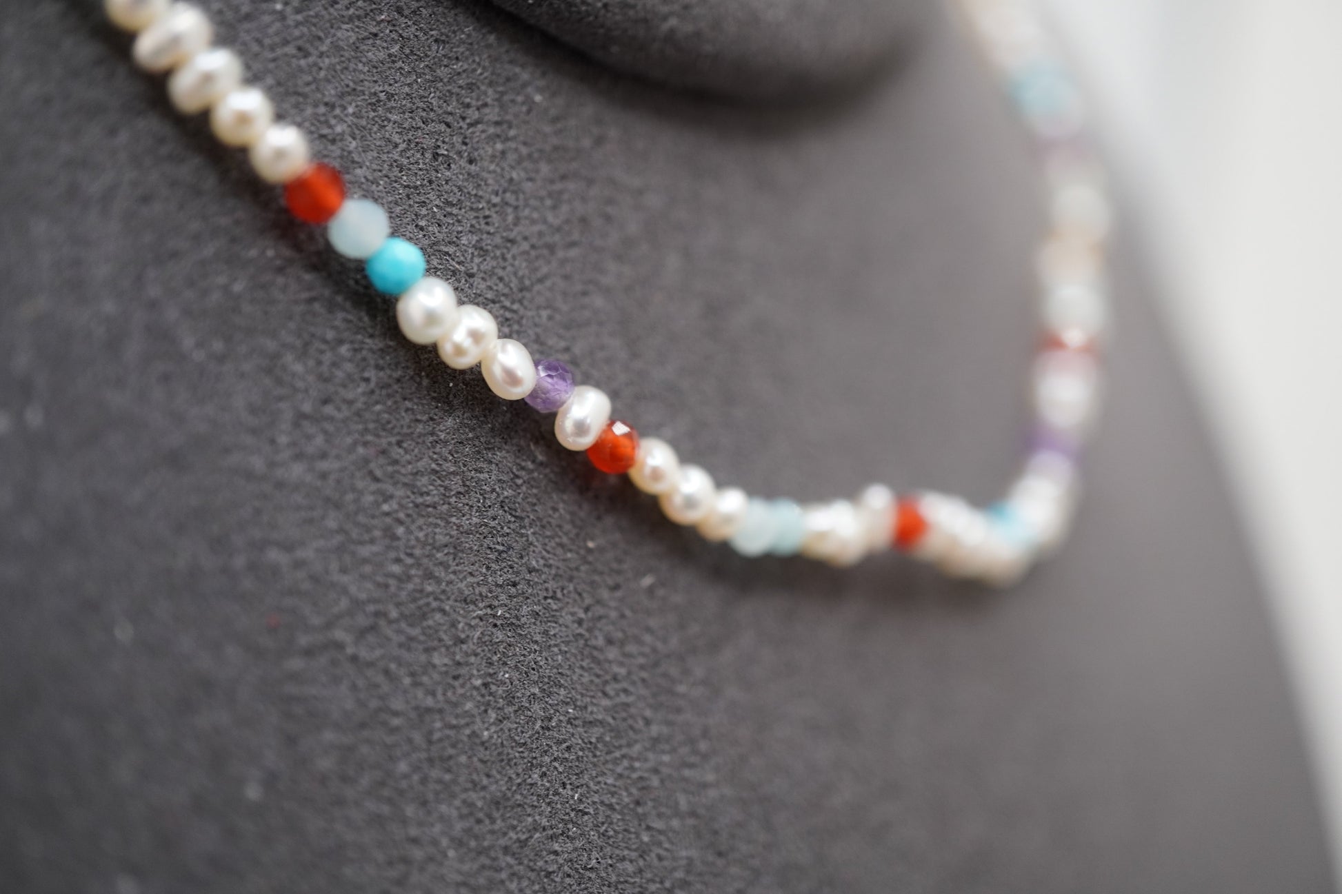 Macro of the Spider Pearl Clasp Bracelet showing 2mm pearls and faceted gemstone markers