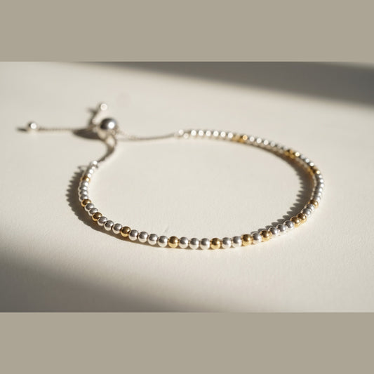 Spider Silver and Gold DNA Profile Bracelet with silver spheres and gold markers, adjustable slider clasp