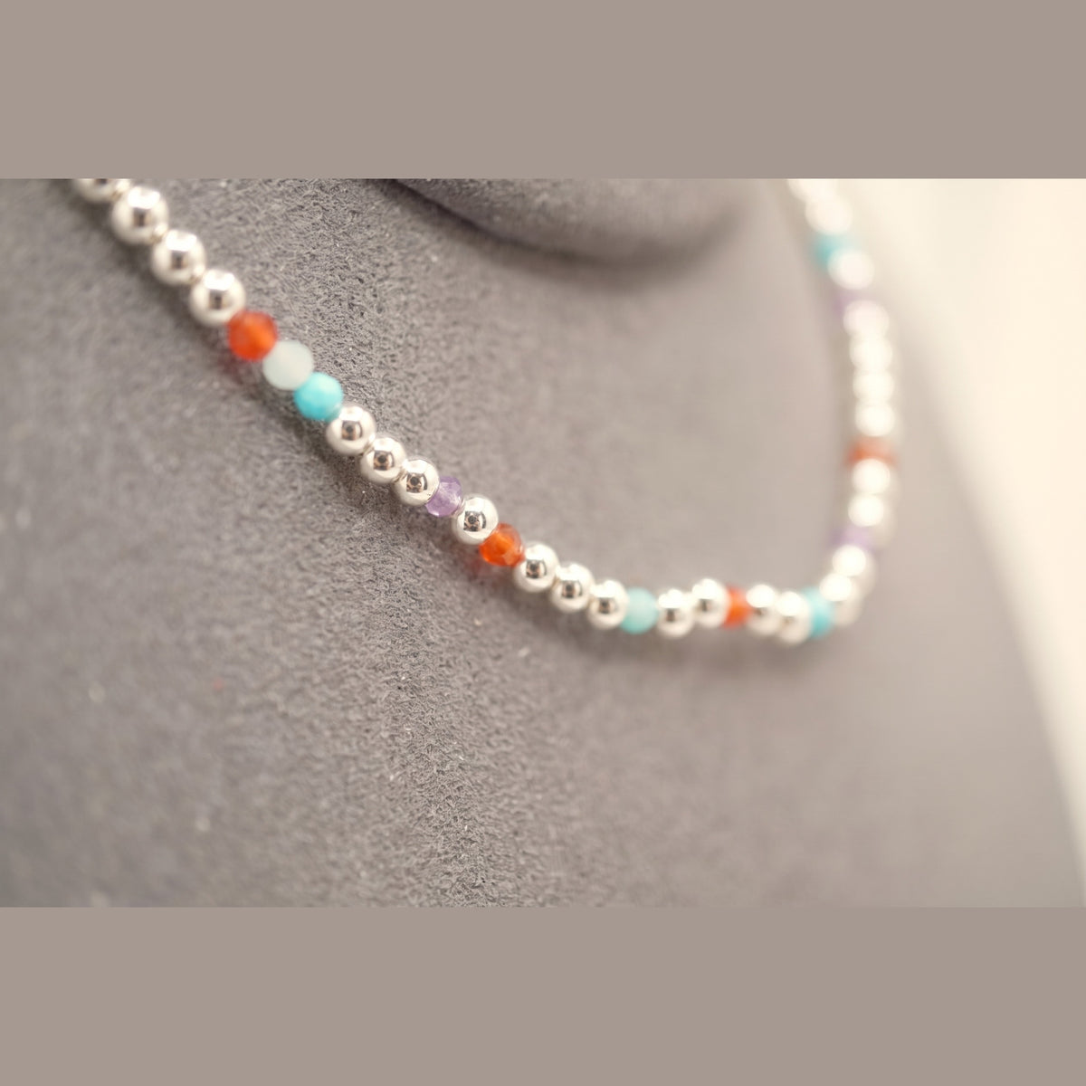 Macro of the Spider Silver Clasp DNA Profile Bracelet showing the 2mm silver spheres and gemstone markers