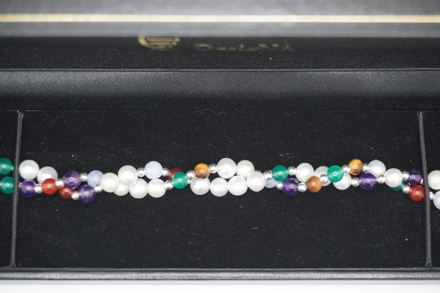 Close up of the Twisted Pearl Bracelet in the DesigNA box