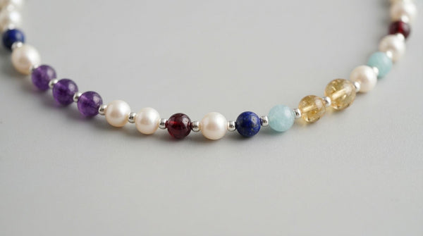 Close up of freshwater pearls and gemstone markers on a DesigNA pearl necklace
