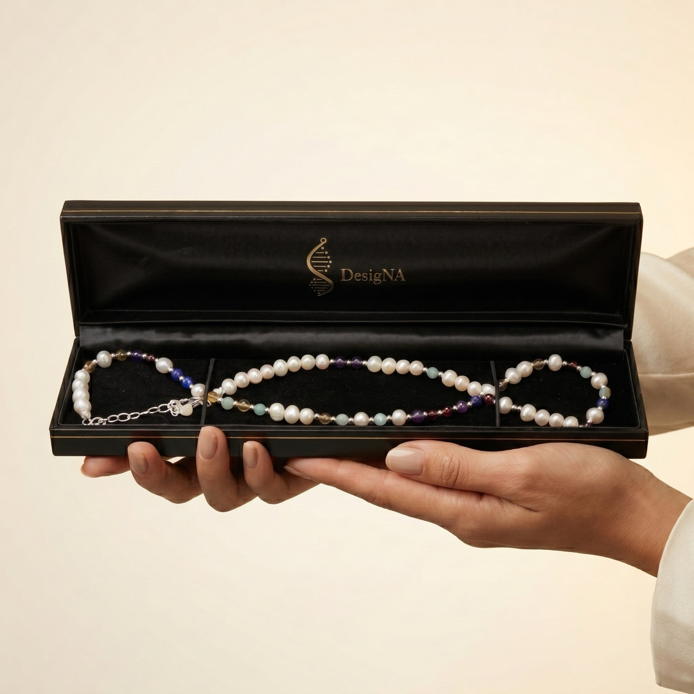 Necklace presented in the open black DesigNA jewellery box