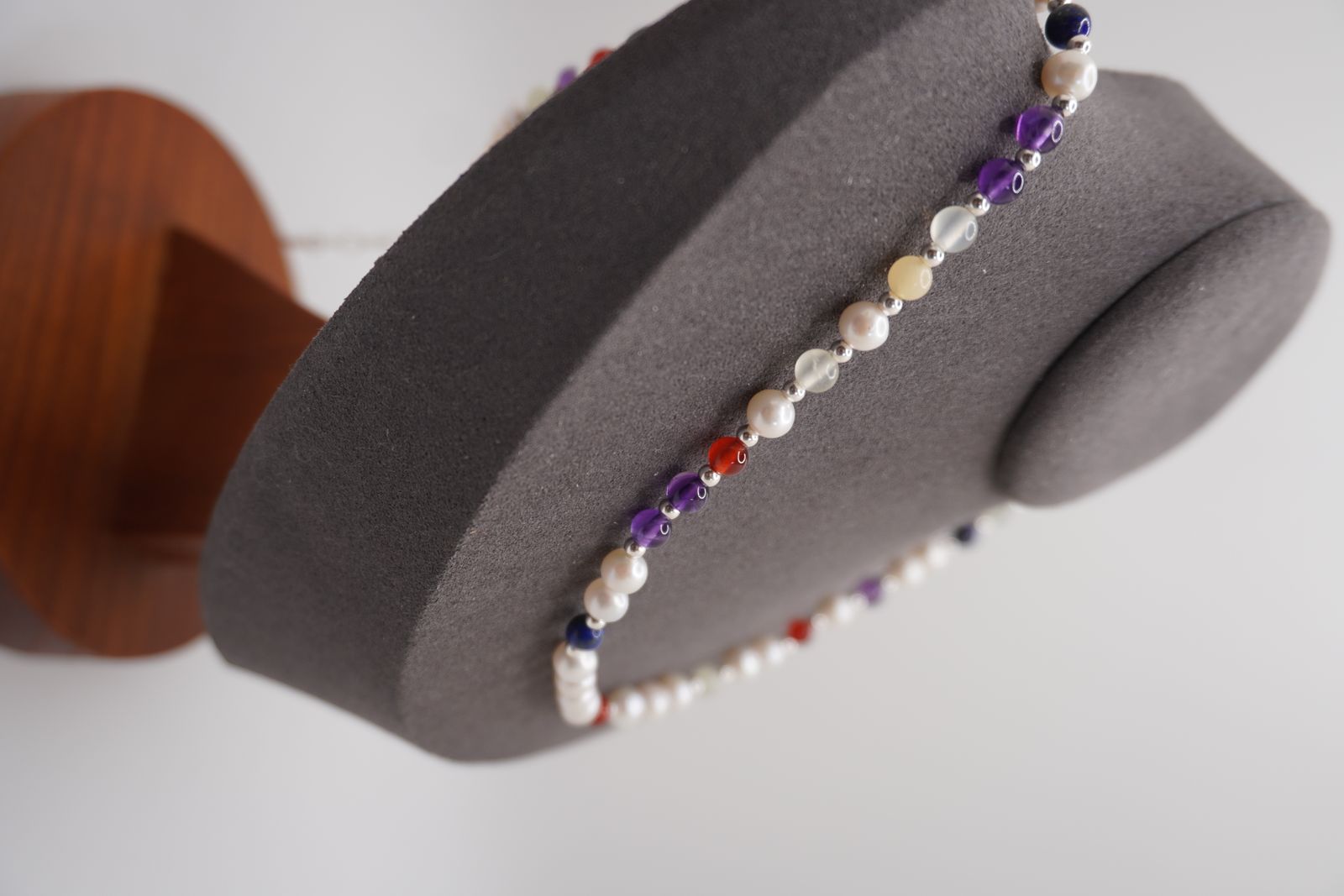The Pearl DNA Profile Necklace on a display bust