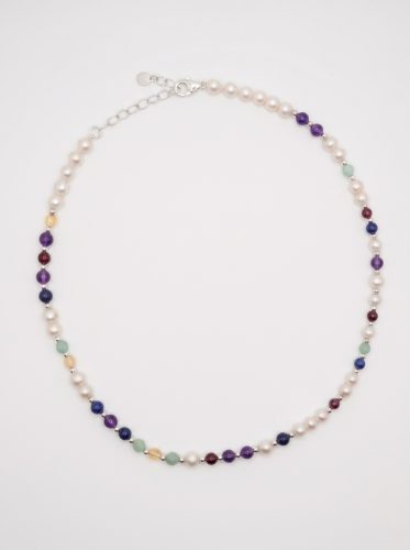 DesigNA pearl DNA necklace worn at the collarbone